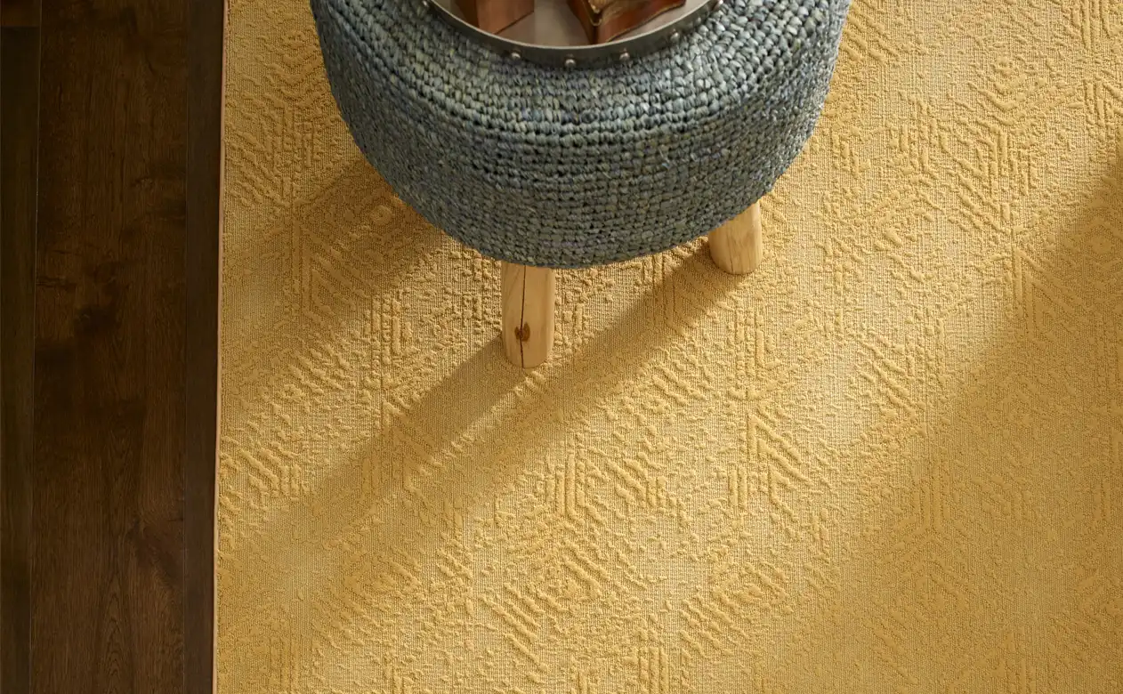 Butter-colored area rug and ottoman. 